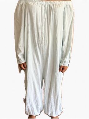Woman’s baggy off-shoulder light mint green Romper with pockets.